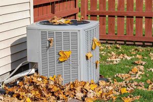 AC repair service for outdoor condenser unit with leaves buildup